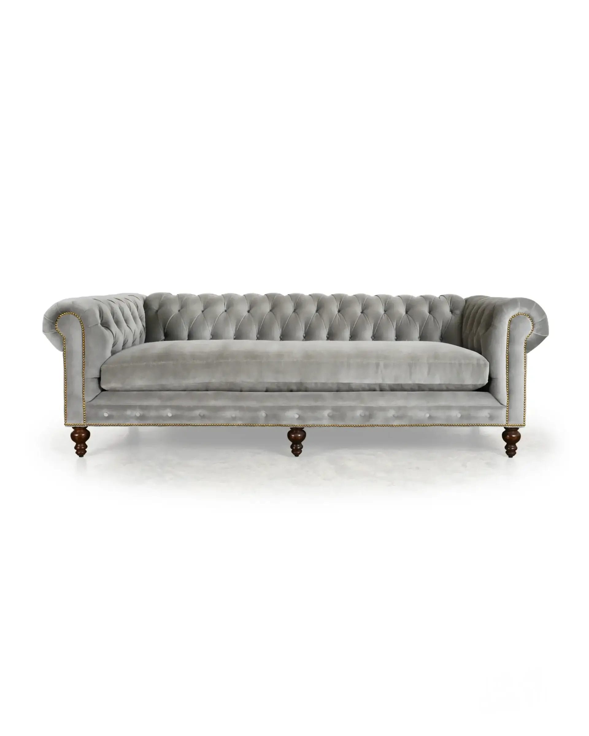 Grey velvet Chesterfield sofa with tufted back and sides at COCOCOHome in Cornelius, perfect for a cozy Charlotte living room.